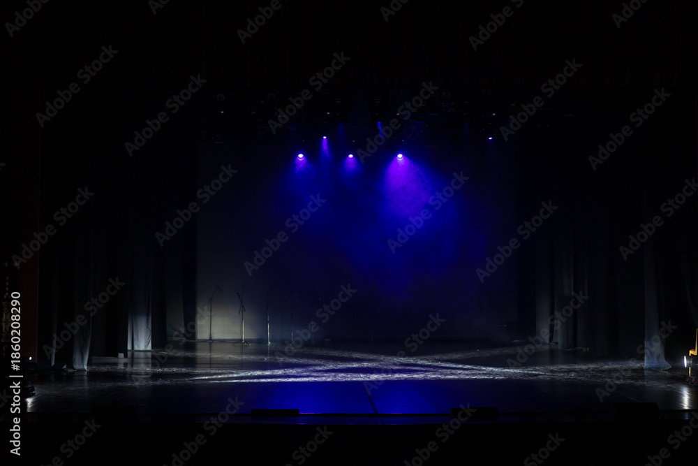 Obraz premium An empty stage of the theater, lit by spotlights and smoke before the performance