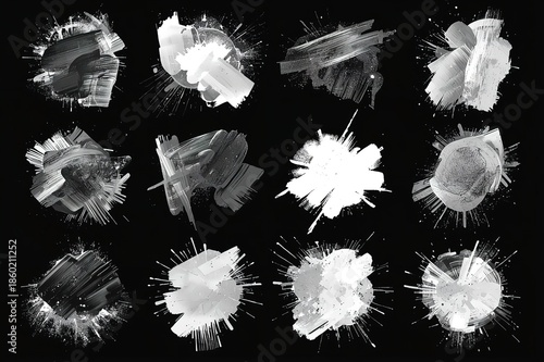 A collection of white paint splatters on a black background