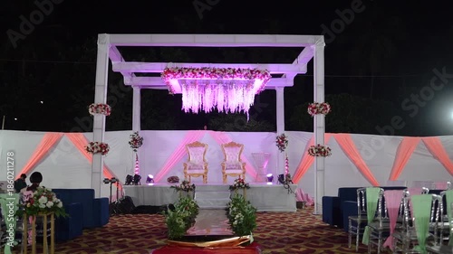 Beautifully decorated wedding venue featuring elegant floral arrangements, soft ambient lighting, and luxurious table settings