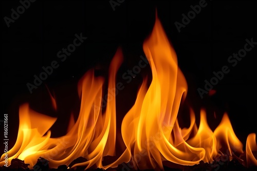 A close-up view of vibrant orange flames burning brightly against a dark background