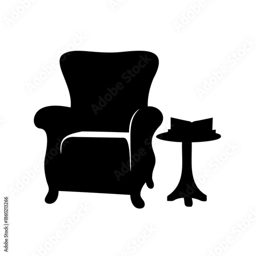 Silhouette of cozy armchair and side table with open book