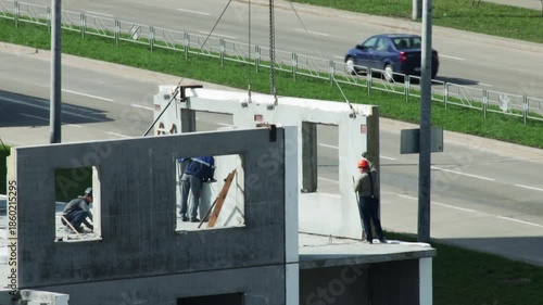 Crane Lowers Prefabricated Wall Section.