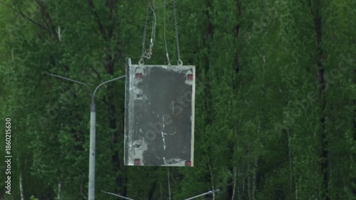 Heavy Machinery Operates Against Green Foliage.