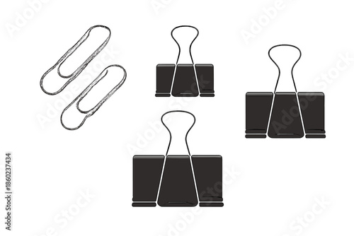 Binder clips and paper clips on a grey background