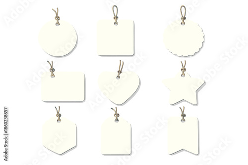 Nine blank tags in various shapes hanging on twine against a gray background