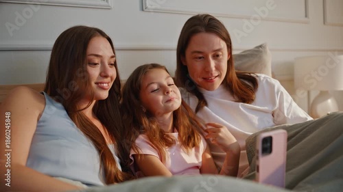 Happy family having videocall sunny house closeup. Couple with little kid girl