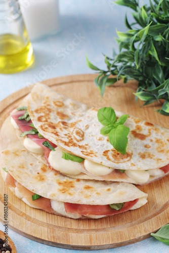 Traditional Italian dish Piadina romagnola - flat bread with mozarella and proscuitto	