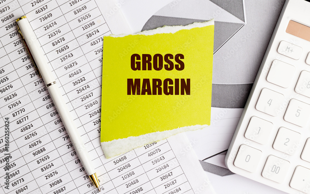 Fototapeta premium Yellow note with text gross margin on financial documents with pen and calculator on office desk