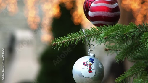 Camera Moves from Red Christmas Ornaments to Snowman Decorated Ball