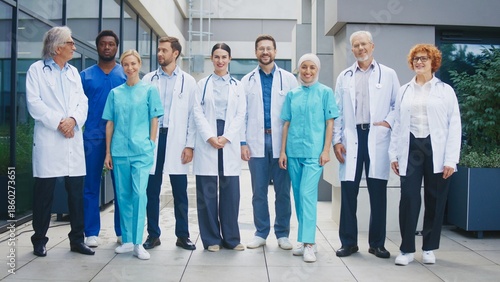 Wallpaper Mural Medical team standing outside clinic smiling and looking directly at camera. Group posing together showing unity and confidence. Professionals presenting friendly attitude during calm moment. Torontodigital.ca