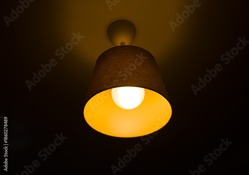 Glowing ceiling lamp at night