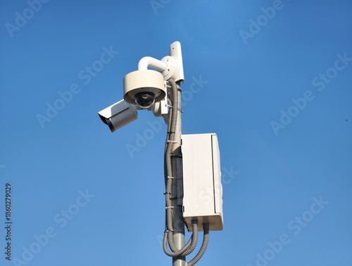 dual surveillance cameras on street pole for retail security