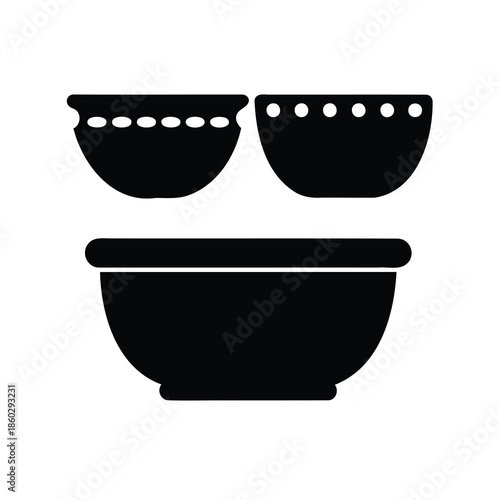 Three stacked bowls with decorative dots on the upper rims, simple design