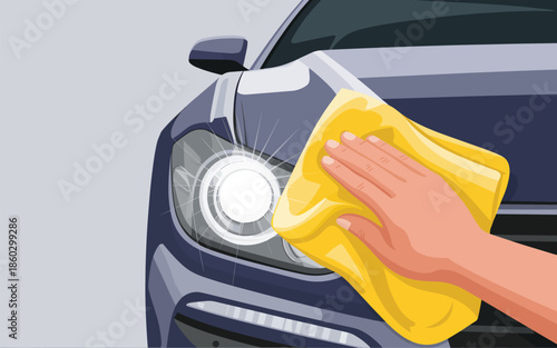 Hand cleaning car headlight with yellow cloth