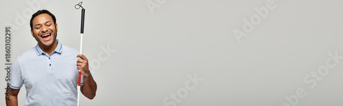 Canvas Print Handsome Indian man radiates joy while navigating his world with a white cane