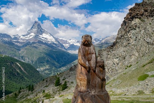 Carving of two marmots with the Matterhorn mountain in the background at Zermatt