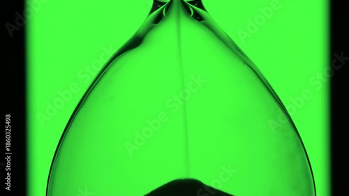 Concept of time passing. hourglass with sand on green background,