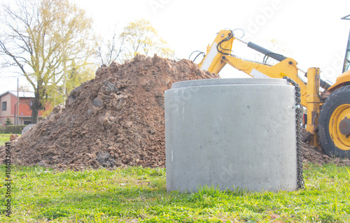 Installation of a reinforced concrete well for water supply and sewerage at a construction site. Well concrete ring for a well.
