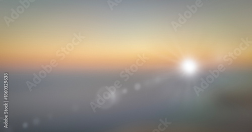 Soft sunrise gradient background with warm pastel colors and gentle sun flare. Minimal abstract sky scene with smooth color transition creating calm and airy atmosphere. Ideal for backgrounds, banners