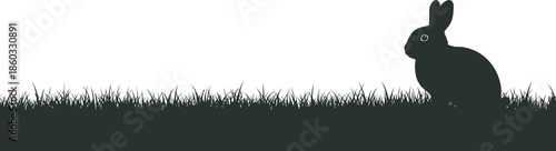 Easter day silhouette of a bunny rabbit in a field on a bright background