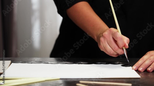 Light, smooth brush movements leave a pattern on the canvas. High quality 4k footage