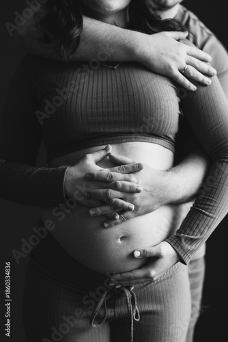 Beautiful pregnancy of young family. Close-up of pregnant woman and man. Happy couple, wife and husband hugging tummy.