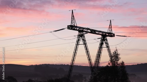 Pylon design, Line sunset, Electric landscape. At dusk, power lines connecting electric towers glowed, showcasing transmission lines.