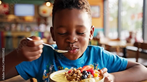 Young person enjoying a meal indoors smiling and eating breakfast cereal