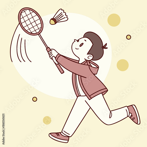 Boy playing badminton with racket and shuttlecock