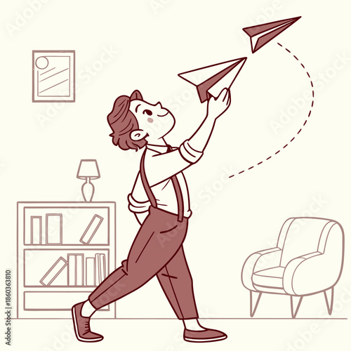 Boy throwing a paper airplane with joy indoors