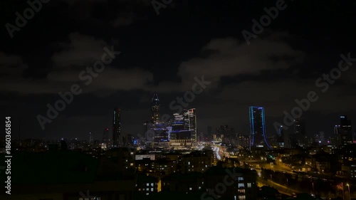 Modern City at Night with Glowing Skyscraper Lights