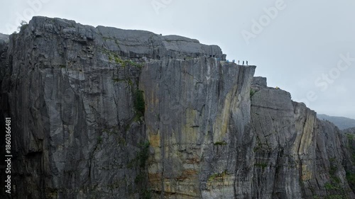 Vertical cliffs of Pulpit Rock Preikestolen Norway. Close aerial view highlights the sheer rock walls and rugged textures, emphasizing the scale of this famous Norwegian tourist landmark.