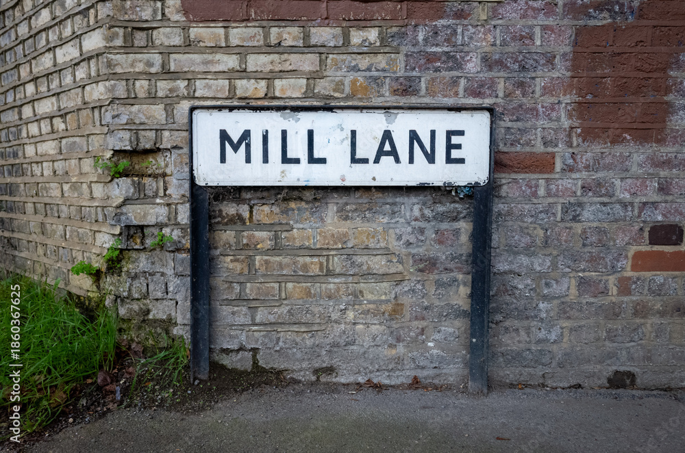 Fototapeta premium Street sign against textured brick wall