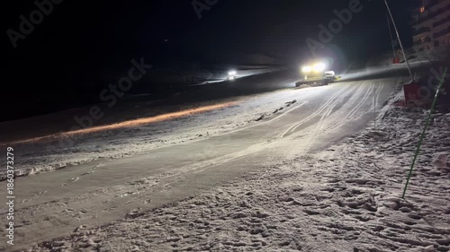 Wallpaper Mural A snowcat removes excess snow from its path, illuminating it spotlights Torontodigital.ca