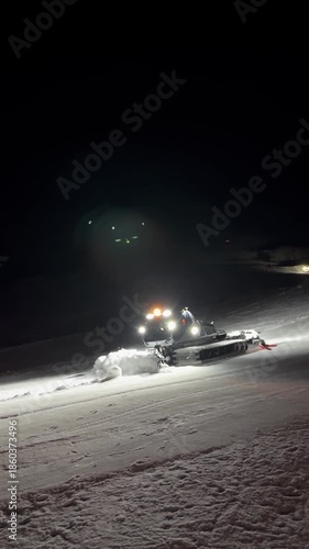 Wallpaper Mural At night snowcat removes excess snow from ski slope, illuminating it spotlights Torontodigital.ca