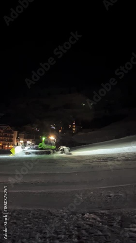 Wallpaper Mural A brightly lit snowcat moves up the ski slope, compacting the snow beneath it Torontodigital.ca