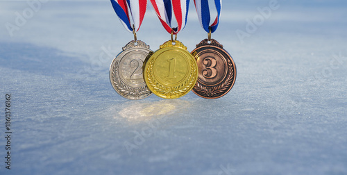 Canvas Print golden medal on the textured ice surface in the snow - winter sport successful c