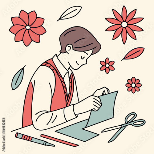 Young boy folding paper with scissors and flowers