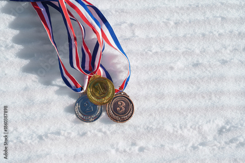 golden medal on the textured ski slopes in the snow - winter sport successful concept. Skiing, biathlon.