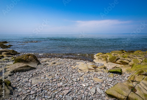 Rocky rugged coast of the Bay of Fundy at the Black Rock Lighthouse on the western side of Nova Scotis Canada