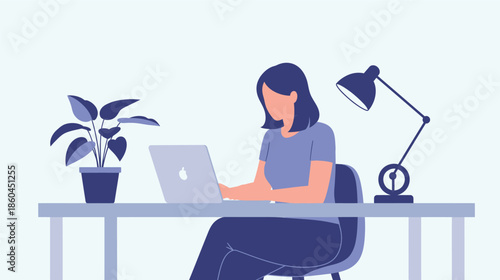 Woman working on laptop at desk with lamp and plant