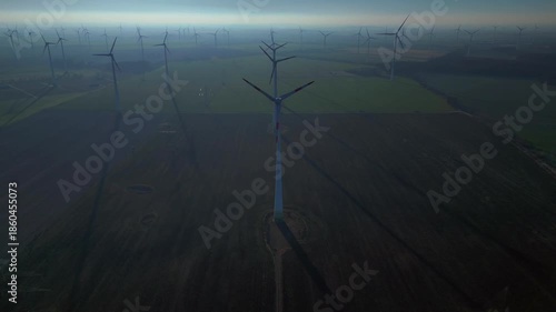 above Wind energy turbines at sunrise, clean power. Lovely aerial view drone