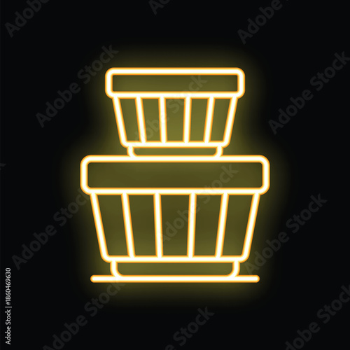 Glowing neon yellow laundry basket stacked over another laundry basket icon on black background