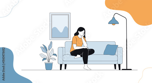 Sad woman sitting alone on a sofa in a living room, looking thoughtful and depressed with a pillow and a floor lamp nearby.