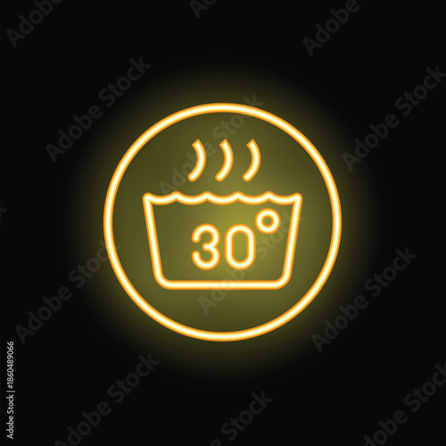 Round glowing yellow neon sign showing the recommended water temperature for washing at thirty degrees celsius