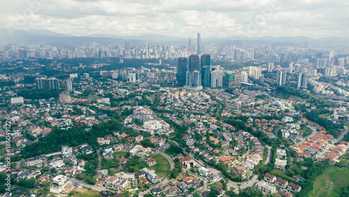 Awesome Kuala Lumpur skyline. Aerial view of a green city park in Kuala Lumpur, Malaysia. Skyscrapers are visible on blue sky  background. Kuala Lumpur is a popular tourist destination of Asia