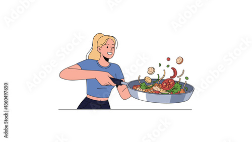 Happy young woman enthusiastically cooking a healthy meal, tossing vegetables and other ingredients in a frying pan with a smile.