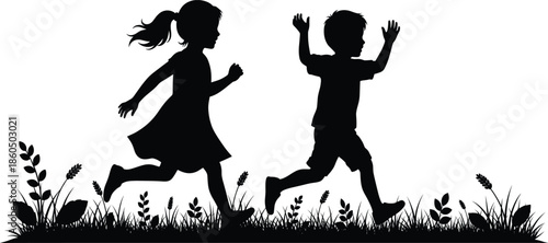 Black silhouette of a young boy and girl running and playing in a meadow with tall grass and wildflowers for childhood and nature concepts