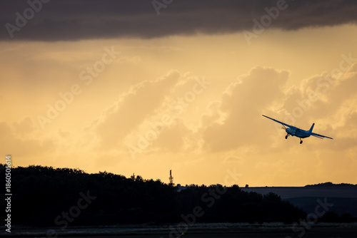 Cuadro en lienzo Aircraft taking off into the sunset, Image shows a cessna 208 taking off during