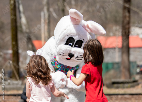 Fotografija Children meet the Easter bunny during an Easter egg hunt at a community park